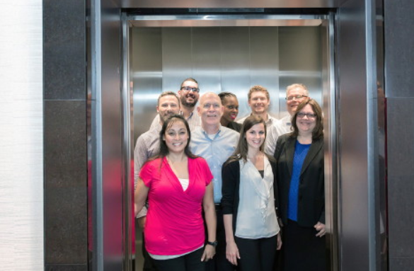 Professional team of elevator technicians in elevator